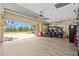 Open garage with a golf cart, epoxy flooring, and plenty of storage space at 16232 Quesa Dr, Punta Gorda, FL 33955