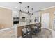 A modern kitchen featuring granite countertops, stainless steel appliances, and an island with seating at 16232 Quesa Dr, Punta Gorda, FL 33955