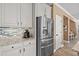 A sleek kitchen featuring white cabinetry, granite countertops, and stainless steel appliances at 16232 Quesa Dr, Punta Gorda, FL 33955