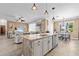 Open-concept kitchen featuring a center island, stainless steel appliances, and seamless flow to the living areas at 16232 Quesa Dr, Punta Gorda, FL 33955