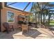 Charming lanai with seating, a table with umbrella and views of the garden at 16232 Quesa Dr, Punta Gorda, FL 33955