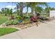 Beautifully landscaped flowerbed with colorful blooms, river rock accents, and manicured lawn, enhancing curb appeal at 16232 Quesa Dr, Punta Gorda, FL 33955