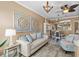 Comfortable living room showcasing stylish seating, decorative wall art, and views into the dining area at 16232 Quesa Dr, Punta Gorda, FL 33955