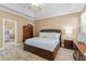 A comfortable main bedroom featuring a ceiling fan, tiled floor, and neutral colors at 16232 Quesa Dr, Punta Gorda, FL 33955