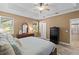 Spacious main bedroom features a bed, wood-look tile floors, and a secure, black Liberty Safe at 16232 Quesa Dr, Punta Gorda, FL 33955