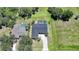 An aerial view shows a single Gathering home with a pool and spacious green surroundings at 16615 Acapulco Rd, Punta Gorda, FL 33955