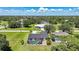 Aerial view of a home with a screened pool surrounded by lush greenery in a residential neighborhood at 16615 Acapulco Rd, Punta Gorda, FL 33955