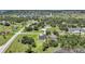 Aerial view showcasing a home with a pool surrounded by lush greenery in a neighborhood at 16615 Acapulco Rd, Punta Gorda, FL 33955
