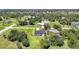 Aerial view showcasing a home with a pool surrounded by lush greenery in a residential neighborhood at 16615 Acapulco Rd, Punta Gorda, FL 33955
