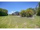 Expansive backyard with a well-maintained lawn and a screened lanai, perfect for enjoying the outdoors at 16615 Acapulco Rd, Punta Gorda, FL 33955