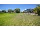 Expansive backyard with a well-maintained lawn and a screened lanai, perfect for enjoying the outdoors at 16615 Acapulco Rd, Punta Gorda, FL 33955