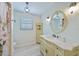 Bathroom with decorative lighting, white cabinets, marble countertops, and floral shower curtain at 16615 Acapulco Rd, Punta Gorda, FL 33955