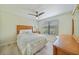 Bedroom features a bamboo headboard, ceiling fan, and light parquet flooring at 16615 Acapulco Rd, Punta Gorda, FL 33955