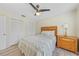 Bedroom with bamboo headboard, ceiling fan, and bright natural light at 16615 Acapulco Rd, Punta Gorda, FL 33955