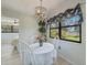 Bright dining area with modern chandelier, white table set, and window at 16615 Acapulco Rd, Punta Gorda, FL 33955