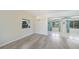 Elegant dining area with modern floors and a clear view into the sunroom, great for entertaining guests at 16615 Acapulco Rd, Punta Gorda, FL 33955