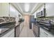 Modern kitchen featuring granite countertops, white cabinets, and stainless steel appliances for a sleek look at 16615 Acapulco Rd, Punta Gorda, FL 33955