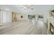 Spacious living area featuring sleek floors, a ceiling fan and a smooth transition to the outdoors at 16615 Acapulco Rd, Punta Gorda, FL 33955