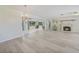 Open living space featuring sleek floors seamlessly connecting the sunroom with a classic fireplace at 16615 Acapulco Rd, Punta Gorda, FL 33955