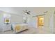 Bright main bedroom features a ceiling fan and door to the main bathroom at 16615 Acapulco Rd, Punta Gorda, FL 33955