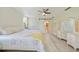 Comfortable main bedroom features white furniture, ceiling fan and access to the main bathroom at 16615 Acapulco Rd, Punta Gorda, FL 33955