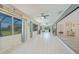 Spacious sunroom with tile flooring, ceiling fans, and bright windows at 16615 Acapulco Rd, Punta Gorda, FL 33955