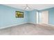 Comfortable blue bedroom with tiled floor and ceiling fan at 18111 Lake Worth Blvd, Port Charlotte, FL 33948