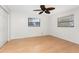Bright bedroom with wood flooring, neutral walls, windows and ceiling fan at 18111 Lake Worth Blvd, Port Charlotte, FL 33948