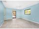 Comfortable blue bedroom with tiled floor and ceiling fan and pool access at 18111 Lake Worth Blvd, Port Charlotte, FL 33948