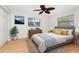 Cozy bedroom showcasing a queen-sized bed, hardwood floors, and natural light at 18111 Lake Worth Blvd, Port Charlotte, FL 33948