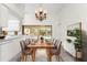 Elegant dining room with seating for six, chandelier, and sliding door to outdoor pool at 18111 Lake Worth Blvd, Port Charlotte, FL 33948