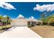 Charming single-story home with a well-kept lawn, driveway, and attached garage, providing curb appeal at 18111 Lake Worth Blvd, Port Charlotte, FL 33948
