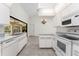 Bright kitchen featuring white appliances, ample counter space, and tile flooring at 18111 Lake Worth Blvd, Port Charlotte, FL 33948