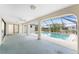 A covered lanai overlooks a screened-in pool, offering a relaxing outdoor living space at 18111 Lake Worth Blvd, Port Charlotte, FL 33948