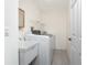 Laundry room with new washer and dryer, utility sink and hanging rack at 18111 Lake Worth Blvd, Port Charlotte, FL 33948