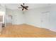 Bright living room featuring wood floors, vaulted ceiling with fan, and white walls at 18111 Lake Worth Blvd, Port Charlotte, FL 33948
