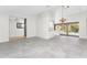 Spacious living room with tile floors connecting to a kitchen and an outdoor pool at 18111 Lake Worth Blvd, Port Charlotte, FL 33948