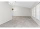 Bright living room with tile flooring and high ceilings, illuminated by a chandelier at 18111 Lake Worth Blvd, Port Charlotte, FL 33948