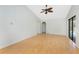 Bright living room featuring wood floors, vaulted ceiling with fan, and white walls at 18111 Lake Worth Blvd, Port Charlotte, FL 33948
