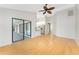 Bright living room featuring wood floors, vaulted ceiling, and sliding glass doors to the lanai at 18111 Lake Worth Blvd, Port Charlotte, FL 33948