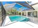 The screened pool offers a private oasis, surrounded by lush greenery and a serene atmosphere at 18111 Lake Worth Blvd, Port Charlotte, FL 33948