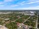 Aerial view of the property in a neighborhood setting surrounded by trees at 19092 Woodbine Ave, Port Charlotte, FL 33954