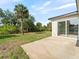 Large backyard with a concrete patio and ample green space with mature trees at 19092 Woodbine Ave, Port Charlotte, FL 33954
