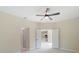 Neutral bedroom featuring light colored walls, ceiling fan, and doorways to other rooms at 19092 Woodbine Ave, Port Charlotte, FL 33954