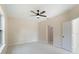 Spacious bedroom featuring neutral walls, tile floors, and a ceiling fan at 19092 Woodbine Ave, Port Charlotte, FL 33954