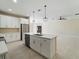 Modern kitchen with an island, stainless steel appliances, pendant lights, and ample counter space at 19092 Woodbine Ave, Port Charlotte, FL 33954