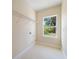 Laundry room featuring tile floors, a window, and utility connections at 19092 Woodbine Ave, Port Charlotte, FL 33954