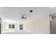 Bright living room featuring large windows, neutral walls, and an open doorway at 19092 Woodbine Ave, Port Charlotte, FL 33954