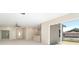 Bright living room with sliding glass doors, a ceiling fan, and views to the backyard at 19092 Woodbine Ave, Port Charlotte, FL 33954