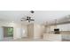 Spacious living room with a ceiling fan, bar, and views to the front door and dining area at 19092 Woodbine Ave, Port Charlotte, FL 33954